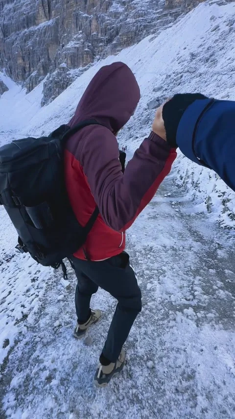 First person view walking carefully along icy snowy hiking trail Stock Footage 330437412