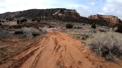 First person view walking down red dirt path. Stock Footage 105143892