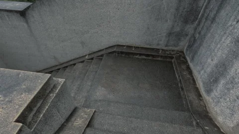 First person view of walking down the old stone stairs towards huge metal doors Stock Footage 278830731