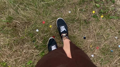 First-Person View of Walking on Grass in Sneakers Stock Footage 304544456