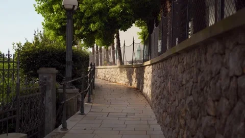 First person View walking on Mediterranean path with stone wall Video stock 277678673
