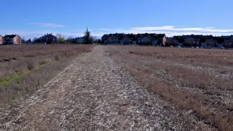 First person view walking on a path in a harvested field Stock Footage 326431297