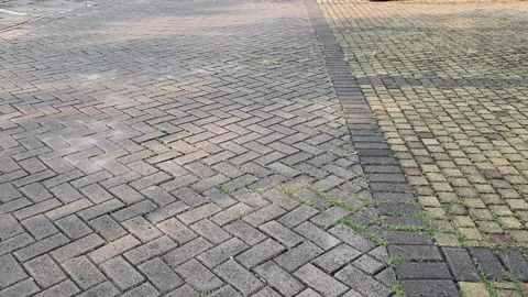 First person view walking on paving block in parking lot Video stock 279296001