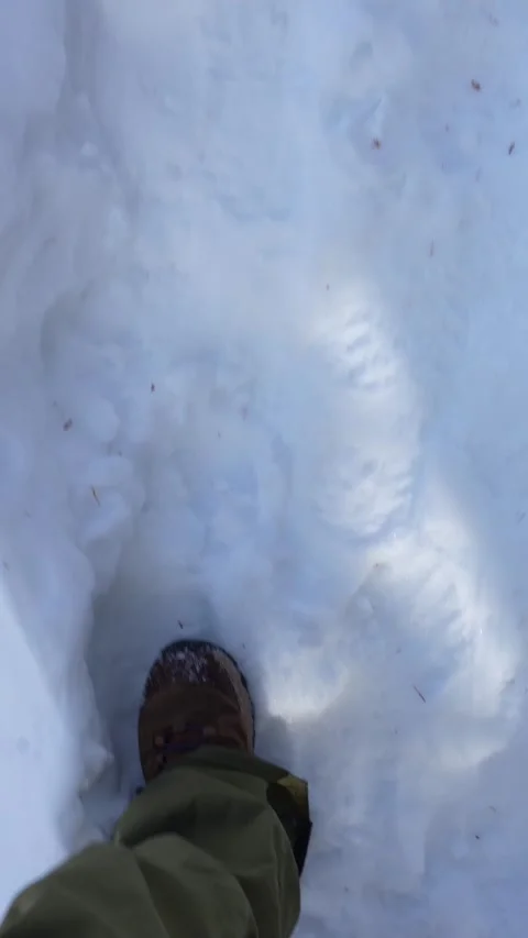 First person view walking through deep snow in winter boots Stock Footage 329624084