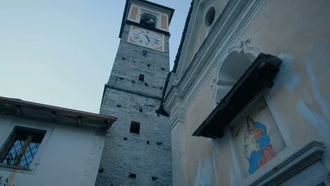 First person view walking towards an old clock tower in Corippo Switzerland. Stock Footage 98180625