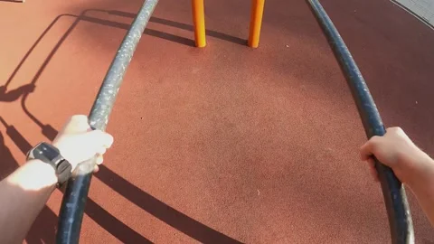 First-person view. Workout. A man does push-ups on the uneven bars in the park Stock Footage 241414394