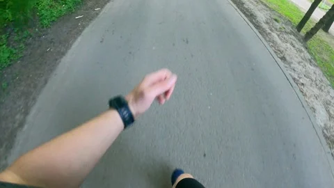 First-person view. Workout. A man runs for a jog on the street in in the park. Stock Footage 241414477