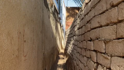 First Person Walk Through Narrow Alley Between Stone Mud Brick Walls Toward  Stock Footage 333246880