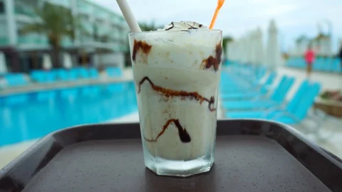 First perspective. Glass with milkshake on a tray. A waiter carries a glass o Stock Footage 121529000