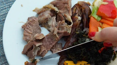 The first perspective of a woman who eats meat with vegetables. Video stock 109091882