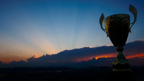 First place winner cup competition with dark clouds and fire sunset Stock Footage 76969435