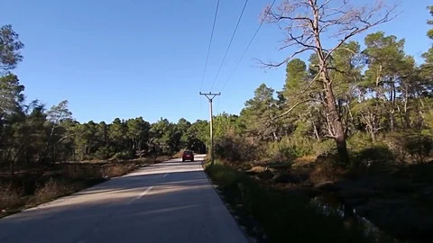 First point of view of driving on a road in countryside, houses, buildings Stock Footage 70451395