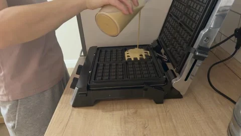 First Portion Of Batter Poured Into Clean Waffle Maker Starting Cooking Process Vidéo 336443525