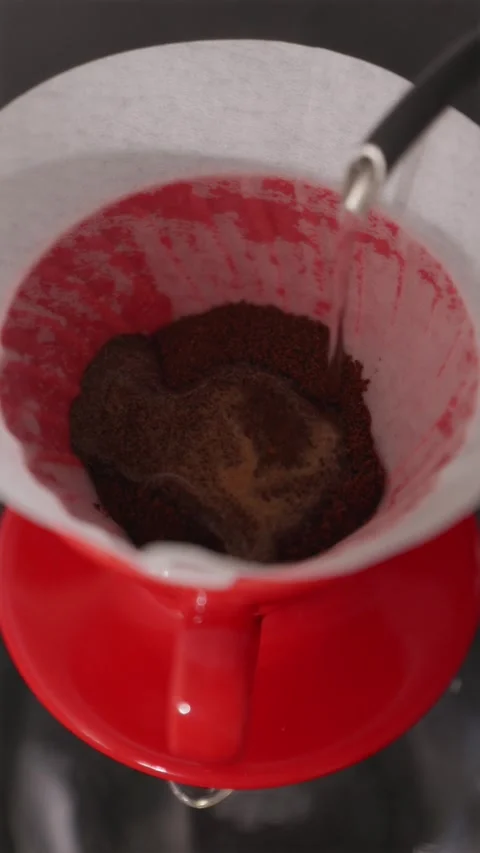First pour and blooming process in V60 coffee brewing Stock Footage 332720158