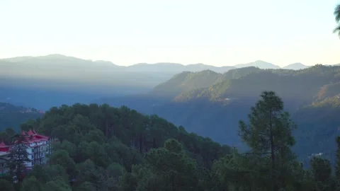 The first ray of morning sunlight falling on the green mountain Stock Footage 220083535