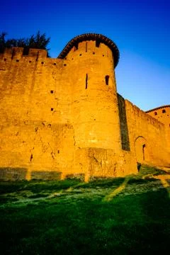 The first rays of dawn sunlight strike the walled Cité de Carcassonne, France  Stock Photos