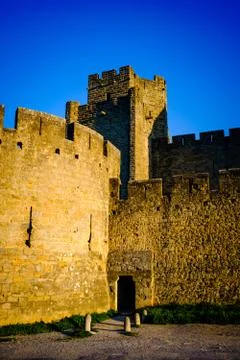 The first rays of dawn sunlight strike the walled Cité de Carcassonne, France  Stock Photos