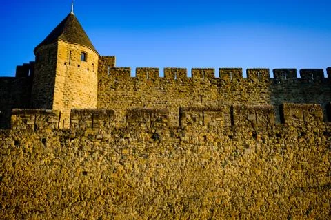 The first rays of dawn sunlight strike the walled Cité de Carcassonne, France  Stock Photos