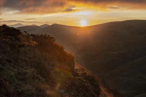 First rays of rising sun on the mountain range 스톡 사진