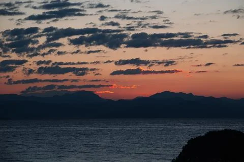 First Rays Of Sun Are Reflected In The Mountains Of Balkan Peninsula, Corfu Stock Photos