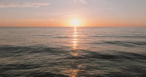 First rays of sun break over ocean horizon Stock Footage 303316776