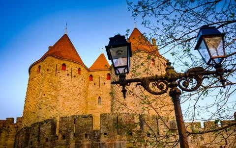 The first rays of sunlight glance across the walls and turrets in Carcassonne Stock Photos