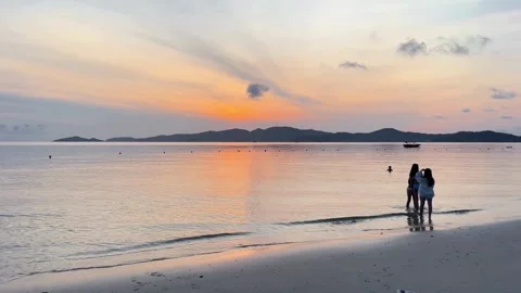 The first rays of sunlight shine down on the beautiful fine white sand Stock Footage 327920365