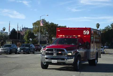 First responder ambulance code three flashing lights siren crossing intersection Stock Photos