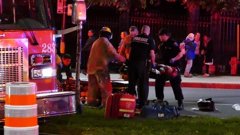 First responders and EMS loading victim on stretcher Stock Footage 119866243