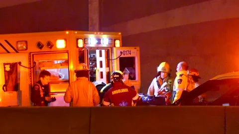 First responders and paramedic loading victim in the ambulance Stock Footage 133275205