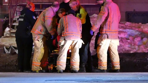 First responders and paramedic taking care of victim on stretcher Stock Footage 105198583