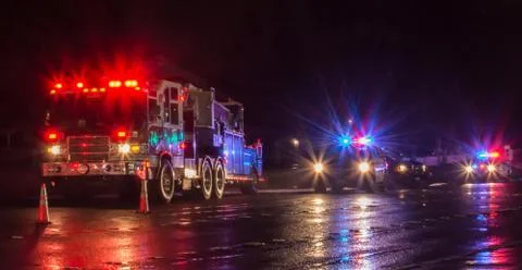 First Responders - firefighters and police officers - on a wet night Stock Photos
