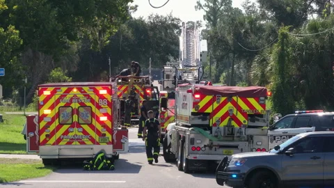 First responders at potential fire hazard at Florida home. Firefighter trucks at Video stock 309942826