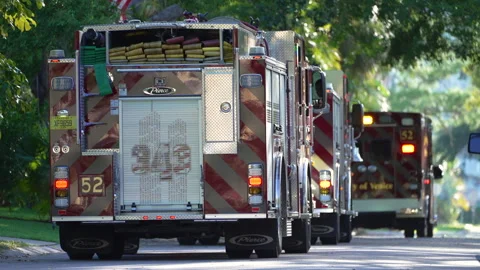 First responders at potential fire hazard at Florida home. Firefighter trucks at Video stock 309943265