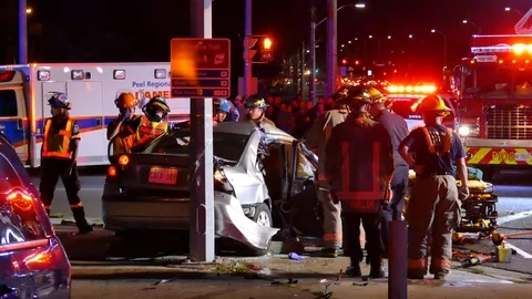 First Responders Stabilizing Patient During Single Vehicle Crash Into Pole - Stock Footage 91565975