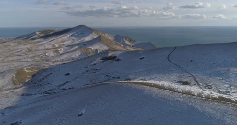 The first snow in the background of the sea and hills 스톡 동영상 102079443