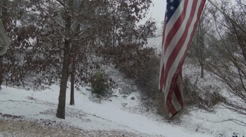 First Snow Fall with US Flag in Foreground Video stock 34480527