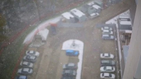 First snow falling in city outside yard house. view from window camerashake. Stock Footage 77437866