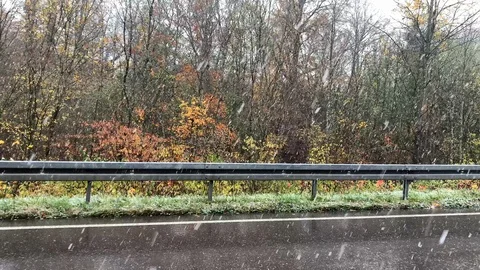 First snow falling on the road view from a car window Stock Footage 122591240