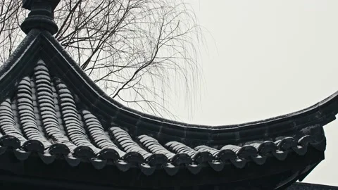 First Snow Falling-Snowflakes Falling from the Cornices of Ancient Chinese B Stock Footage 233579214