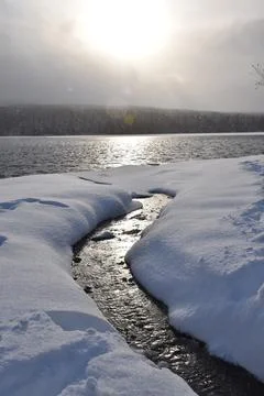 The first snow on the lake in the fall Stock Photos