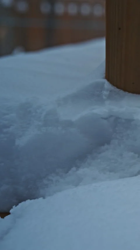 First snowfall forming a thick layer on outdoor deck railing Video stock 324889312