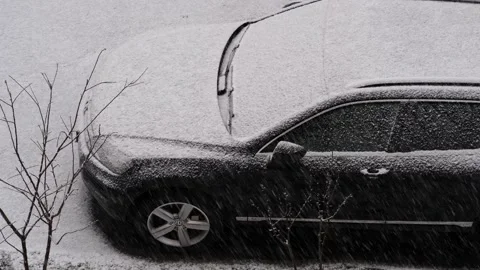 The first snowfall, the onset of winter. The yard and the car are covered Stock Footage 257427728