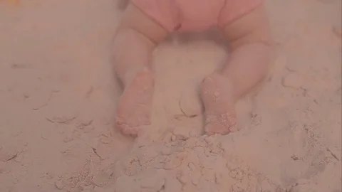 A first step of baby at the sand beach. A little girl walks the sand Stock Footage 73909616