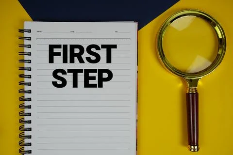 First Step text with magnifying glass on yellow background Stock Photos