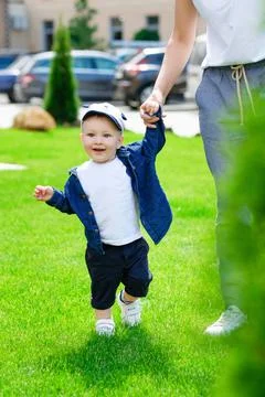 First steps. Baby learning to walk, with help of mothers hands Foto stock