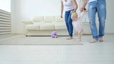 First steps of baby toddler learning to walk in white sunny living room Stock Footage 114872759
