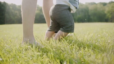 The first steps of the child on the grass Video stock 77198387