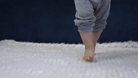 First steps. Kid learns to walk at home. Happy kid is taking first steps. Child 스톡 동영상 154999547