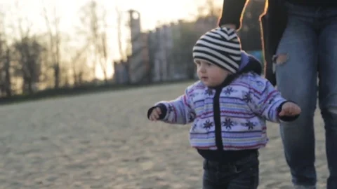 First steps of little boy at river shore Stock Footage 74619118